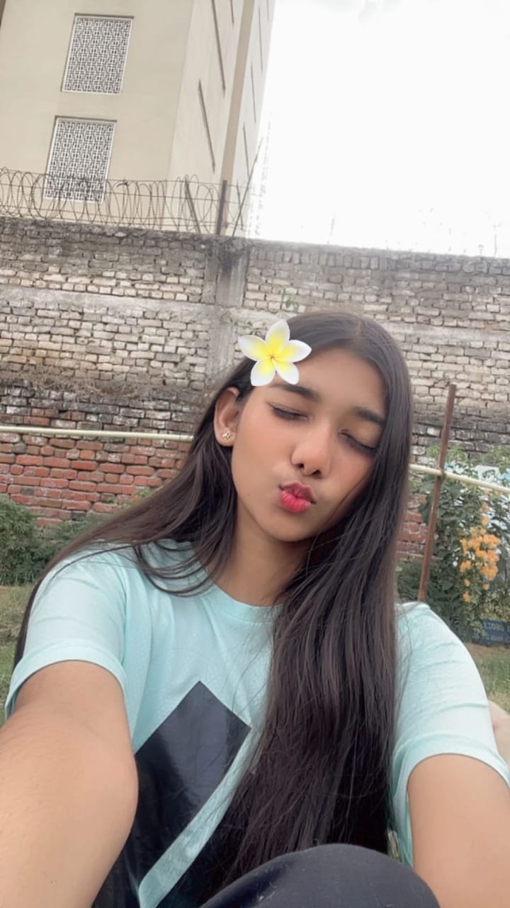 Kamya with a white plumeria flower